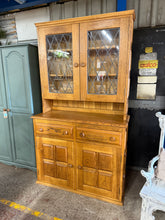 Load image into Gallery viewer, This beautiful heavy oak dresser is solidly built and well maintained. Previous owners made small repairs to the cornice and plinth, but they are barely visible. It offers plenty of storage with two shelves above two dovetail-jointed drawers and a cupboard. For easier transport, the dresser can be separated into two parts.
Overall Dimensions
113cm wide x 45cm deep x 198cm high
DELIVERY AVAILABLE      
For our other items see our website https://fossewayfurniture.co.uk
collection from our shop at cv36,