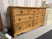 Load image into Gallery viewer, This charming vintage pine chest of drawers combines timeless appeal with practical storage. Structurally sound and well-maintained, it features authentic dovetail jointed construction with three short drawers over four generous long drawers—ideal for bedrooms, living spaces, or hallways. Light wear consistent with age adds character without compromising quality. A versatile piece that brings warmth and functionality to any room. 