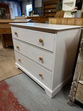 Load image into Gallery viewer, Discover the potential in this charming wooden chest of drawers, ready for a fresh new look. Featuring three spacious dovetail-jointed drawers, it offers reliable storage. The existing gloss white finish shows character and patina, presenting an ideal canvas for your personal touch—whether you choose to refresh it or embrace its vintage appeal. Structurally robust and well-maintained, this piece combines practical functionality with timeless design, making it a worthwhile addition to any bedroom or living s