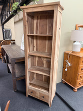 Load image into Gallery viewer, Stunning stripped mango wood bookcase with rustic character. Features 3 fixed shelves and 2 practical drawers, ideal for displaying books and storing essentials. Stripped to natural wood finish—a light wax coat recommended for protection and enhanced durability. Genuinely pre-loved with honest wear marks and a cable hole from previous use, but structurally sound and ready for a new home. Perfect for those who appreciate vintage charm and sustainable furniture.
Delivery Available
Overall Dimensions
61cm w