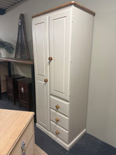 Load image into Gallery viewer, A charming two-tone cream wardrobe offering practical storage in a compact footprint. Features one full-height cupboard with hanging rail, one shorter cupboard with hanging rail, and three drawers—ideal for narrow spaces. Structurally sound with minor cosmetic marks consistent with pre-loved furniture. Great condition overall.
Delivery Available
Overall Dimensions
74cm wide x 47cm deep x 181cm high