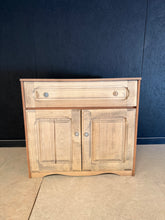 Load image into Gallery viewer, A charming oak cabinet with authentic character. This piece has been stripped back to reveal natural wood grain, showcasing its original beauty. Features a lift-up lid above a double cupboard with internal shelf—ideal for storage and display. The natural finish may benefit from a protective coat of wax to enhance durability. Light surface marks add to its vintage appeal and honest provenance. Perfect for adding warmth and functionality to any room.
Delivery Available
Overall Dimensions
89cm wide x 49.5cm