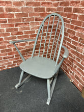 Load image into Gallery viewer, A charming vintage Ercol rocking chair with timeless appeal. Currently finished in grey, it offers a blank canvas for personalisation or restoration to its original wood tone. Structurally sound and well-maintained, this classic piece is ideal for creating a cosy fireside retreat. A genuine mid-century design that combines comfort with enduring craftsmanship.
Delivery Available
Overall Dimensions
approx : 60cm wide x 71cm deep x 86cm high 