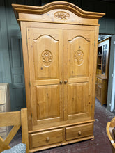 Load image into Gallery viewer, A striking solid pine wardrobe offering generous storage with one hanging rail and two shallow drawers. This three-section design separates for convenient transport and repositioning. Structurally sound with minor cosmetic marks that reflect its character. A statement piece combining practicality with natural wood appeal.
Delivery Available
Overall Dimensions
122cm wide x 63cm deep x 212cm high