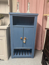 Load image into Gallery viewer, This French hand-painted blue cupboard combines vintage character with practical storage. Structurally sound and in good overall condition, it bears the gentle patina of age with only minor signs of use that add to its authentic appeal. The piece features a double cupboard design with one shelf and a slatted base shelf, offering flexible storage solutions. Ideal for kitchens, bathrooms, or any room needing distinctive storage with charm.
Delivery Available
Overall Dimensions
60cm wide x 27.5cm deep x 111