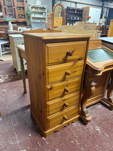 Load image into Gallery viewer, Built from solid pine, this tallboy combines durability with authentic vintage appeal. Five dovetail-jointed drawers provide generous storage capacity, while minor surface marks reflect its character. The piece remains in sound condition and ready for everyday use.
Delivery Available
Overall Dimensions
43cm wide x 40.5cm deep x 95cm high 