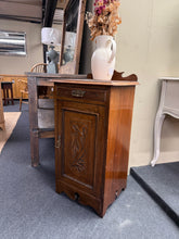 Load image into Gallery viewer, A charming mahogany Victorian pot cupboard in structurally sound condition. This characterful piece features authentic period styling with one practical drawer positioned above a single cupboard housing an internal shelf—ideal for storing tableware, linens, or decorative items. As a pre-loved antique, it displays gentle patina and light surface marks consistent with age and use, adding to its genuine vintage appeal. A versatile addition to period homes or those seeking authentic Victorian furniture.
Delive