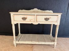 Load image into Gallery viewer, A charming solid pine hall table with a white distressed finish that adds character to any entryway. Features two dovetail-jointed drawers and a lower shelf, providing practical storage for keys, post, and everyday essentials. Structurally sound and in good condition, this piece combines functionality with vintage appeal.
Delivery Available
Overall Dimensions
107.5cm wide x 46cm deep x 87cm + 12cm high