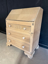 Load image into Gallery viewer, A beautiful stripped oak bureau with authentic character and practical appeal. This piece features a pull-down writing desk and three spacious dovetail-jointed drawers, offering generous storage for any room. The natural wood has been stripped back to reveal the grain, creating a warm, timeless finish that benefits from a protective coat of wax. Structurally sound and in excellent condition, it's ready to become a cherished addition to your home.
Delivery Available
Overall Dimensions
76cm wide x 42.5cm d