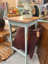 Load image into Gallery viewer, A charming oak side table featuring duck egg blue painted legs, combining classic wood craftsmanship with contemporary colour. In excellent condition and structurally sound, it's ideal as a plant stand, bedside companion, or convenient surface beside your sofa. The natural oak top pairs beautifully with the soft blue finish for a versatile accent piece that complements both traditional and modern interiors.
Delivery Available
Overall Dimensions
41cm wide x 41cm deep x 71.5cm high