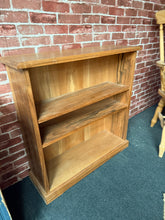 Load image into Gallery viewer, This charming hardwood bookcase is sturdy and in great condition. While it has a few small signs of wear, they are hardly noticeable. With its two spacious shelves, it provides plenty of room to display your books and decorative items.
Delivery Available
Overall Dimensions
85.5cm wide x 27cm deep x 86cm high 