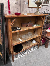 Load image into Gallery viewer, A characterful vintage bamboo bookcase with genuine patina from years of use. Three fixed shelves provide reliable storage for books and display pieces. The frame remains solid and stable, with only minor surface marks that add to its authentic appeal. A practical choice for those seeking vintage charm with honest wear.
Delivery Available
Overall Dimensions
91.5cm wide x 34cm deep x 101cm high