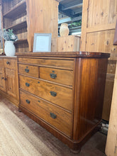 Load image into Gallery viewer, This authentic Victorian mahogany chest of drawers combines period charm with practical storage. Structurally sound and in good overall condition, it features two short dovetail-jointed drawers over two generous long drawers, plus a hidden top drawer for added intrigue. The piece shows gentle signs of age with minor surface marks. A true statement piece for collectors and period home enthusiasts.
Delivery Available
Overall Dimensions
112cm wide x 52.5cm deep x 87.5cm high