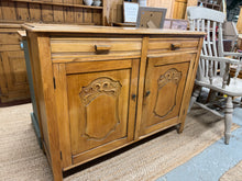 Load image into Gallery viewer, This charming wooden sideboard, likely made of oak, is solidly built. While it shows some marks, they are minor and don’t affect its sturdiness. It offers plenty of storage space with two dovetail-jointed drawers above a double cupboard featuring an internal shelf. With a bit of care, this sideboard will look as good as new.
Overall Dimensions
120cm wide x 40cm deep x 91cm high
DELIVERY AVAILABLE
HAVE THIS PAINTED A COLOUR OF YOUR CHOICE FOR AN EXTRA £80 OR HAVE IT COMPLETELY STRIPPED BACK FOR JUS