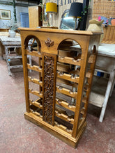 Load image into Gallery viewer, This stunning solid wooden carved wine rack is structurally sound and in great condition. It does have a few marks but nothing too major at all. This can hold 24 bottles.
Overall Dimensions
68cm wide x 30.5cm deep x 103.5cm high 
DELIVERY AVAILABLE    
For our other items see our website https://fossewayfurniture.co.uk
collection from cv36 or bs36