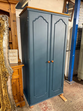 Load image into Gallery viewer, This pine wardrobe has been painted in a deep blue with the top, feet and knobs left natural. Inside there is a long shelf for storage, however it does need a hanging rail installed but this can be done. It is structurally sound and in overall good condition.
Overall Dimensions
85cm wide x 54cm deep x 178cm high 
DELIVERY AVAILABLE    
For our other items see our website https://fossewayfurniture.co.uk
collection from cv36 or bs36