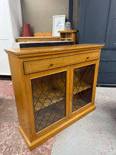 Load image into Gallery viewer, A characterful oak bookcase combining storage and display. Features a dovetail-jointed drawer above a glazed cupboard with internal shelf, ideal for keeping treasured items visible and protected. The piece shows authentic signs of age and use, adding to its vintage charm. Includes original key. Perfect for period homes or those seeking genuine vintage furniture with practical storage.
Delivery Available
Overall Dimensions
107cm wide x 32.5cm deep x 94cm high