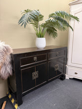 Load image into Gallery viewer, A timeless Oriental sideboard combining functionality with distinctive character. Built with solid construction, this piece features two spacious long drawers positioned above two double cupboards, offering ample storage for any room. Showing natural signs of use with minor surface marks. A striking focal point that brings warmth and sophistication to living spaces, bedrooms, or dining areas. Perfect for those seeking authentic, vintage furniture with lasting appeal.
Delivery Available
Overall Dimensions