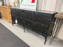 Load image into Gallery viewer, This striking industrial sideboard combines robust metal construction with practical storage. Featuring two double cupboards, it offers ample space for dining essentials while serving as a bold focal point in any room. Built to last, this piece brings authentic industrial character to modern interiors.
Delivery Available
Overall Dimensions
157cm wide x 48cm deep x 77cm high