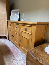 Load image into Gallery viewer, A classic oak sideboard combining timeless design with practical storage. Features three dovetail-jointed drawers above a double and single cupboard, offering versatile space for dining room essentials. Structurally sound with minor surface wear consistent with use. Includes cable access hole at the rear for modern convenience.
Delivery Available
Overall Dimensions
147cm wide x 40cm deep x 86cm high