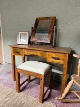 Load image into Gallery viewer, This elegant Myakka sheesham hardwood dressing table combines durability with practical design. Structurally sound and well-maintained, it features a detachable mirror for convenient transport and rearrangement. Three generous drawers—two short and one long—provide ample storage for cosmetics, jewellery, and accessories. Minor surface marks add character to this timeless piece. Ideal for bedrooms seeking both functionality and natural wood beauty.

Delivery Available

Overall Dimensions

110cm wide x 40cm d
