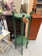 Load image into Gallery viewer, A charming wooden plant stand finished in Farrow &amp; Ball's sophisticated 'Beverly'. This statement piece combines timeless design with practical functionality, perfect for displaying greenery or decorative objects. Shows gentle signs of use, adding character and authentic vintage appeal. Structurally sound and ready to enhance any room with understated elegance.

Delivery Available

Overall Dimensions

33cm x 33cm x 92cm high

