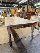 Load image into Gallery viewer, Experience the perfect blend of style and functionality with the 8ft Farmhouse Table. Made of solid pine, this structurally sound table is built to last and is in overall good condition. The charming marks only add to its aesthetic appeal. Plus, the removable legs and handy front drawer ensure easy movement and convenient storage options.

Overall Dimensions

244cm long x 104cm wide x 79cm high

DELIVERY AVAILABLE      

HAVE THIS PAINTED A COLOUR OF YOUR CHOICE FOR AN EXTRA £125 OR HAVE IT COMPLETELY STRIP
