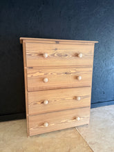 Load image into Gallery viewer, A charming stripped pine chest featuring four spacious drawers, perfect for bedroom or living room storage. Returned to its natural wood finish, this piece showcases authentic grain and character. Structurally sound and ready to use—a light coat of wax will enhance protection and bring out the wood's warmth.&nbsp;

Delivery Available

Overall Dimensions

86cm wide x 39cm deep x 107cm + 6cm high&nbsp;

