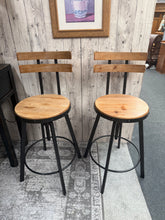 Load image into Gallery viewer, A versatile pair of industrial-style bar stools, perfect for kitchen islands and breakfast bars. Both stools are structurally sound and fully functional. As pre-loved pieces, they show honest signs of use with minor surface marks that add to their authentic character. Ideal for creating a casual, industrial aesthetic in your dining space.

