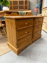 Load image into Gallery viewer, A charming pair of solid pine bedside tables, structurally sound and fully functional. Each features three dovetail-jointed drawers for convenient storage. As used pieces, they display natural wear and patina consistent with age and use, including minor marks and surface damage to one unit. Perfect for adding character and warmth to a bedroom.

Delivery Available

Overall Dimensions

50cm wide x 39cm deep x 69cm/75cm high

