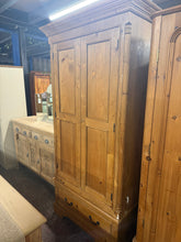 Load image into Gallery viewer, This charming vintage pine wardrobe blends authentic character with practical storage. Structurally sound, it shows gentle signs of age and previous care—marks and filled areas that add to its vintage appeal and can be refreshed with wax or paint to suit your style.
Inside, you'll find one hanging rail for garments and a spacious dovetail-jointed drawer for folded items or accessories. The piece comes complete with its original key, preserving that period detail.

Designed with practicality in mind, it disa
