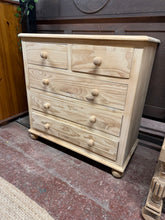 Load image into Gallery viewer, Discover the natural beauty of this stripped pine chest of drawers, showcasing distinctive grain patterns reminiscent of zebra stripes. Featuring solid construction with 2 shallow dovetail-jointed drawers positioned above 3 deeper drawers, it offers versatile storage for any room. The piece is in excellent structural condition and ready to use, though a protective wax finish would enhance its longevity and appearance.

Delivery Available

Overall Dimensions

82cm wide x 40cm deep x 82.5cm high&nbsp;

