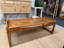 Load image into Gallery viewer, This beautiful coffee table features a sturdy teak frame with a stylish tile top. It’s in great overall shape with only a few small marks, showing its gentle use. A wonderful choice to brighten up any living room space!

Overall Dimensions

117cm wide x 50cm deep x 42.5cm high

DELIVERY AVAILABLE      

For our other items see our website https://fossewayfurniture.co.uk

collection from our shop at CV36 4QZ or purchase online for delivery.

