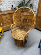 Load image into Gallery viewer, A captivating statement piece that commands attention in any room, this rattan peacock chair combines timeless elegance with practical durability. Crafted with solid structural integrity, it's ready to become your favourite relaxation spot. While it bears the gentle patina of character—subtle marks that only add to its authentic charm—this chair remains in excellent working condition. Perfect for those who appreciate vintage appeal without compromise.

Overall Dimensions

approx : 71cm wide x 40cm deep x 11
