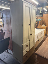Load image into Gallery viewer, A charming two-tone cream wardrobe offering practical storage in a compact footprint. Features one full-height cupboard with hanging rail, one shorter cupboard with hanging rail, and three drawers—ideal for narrow spaces. Structurally sound with minor cosmetic marks consistent with pre-loved furniture. Great condition overall.

Delivery Available

Overall Dimensions

74cm wide x 47cm deep x 181cm high

