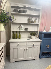 Load image into Gallery viewer, This charming grey-painted pine dresser combines vintage character with practical storage. Featuring a distressed finish that enhances its rustic appeal, it showcases three open shelves above two dovetail-jointed drawers and a spacious double cupboard below. Structurally sound and in excellent condition, it's an ideal piece for adding warmth and functionality to any room.

Delivery Available

Overall Dimensions

116.5cm wide x 45cm deep x 205cm high

