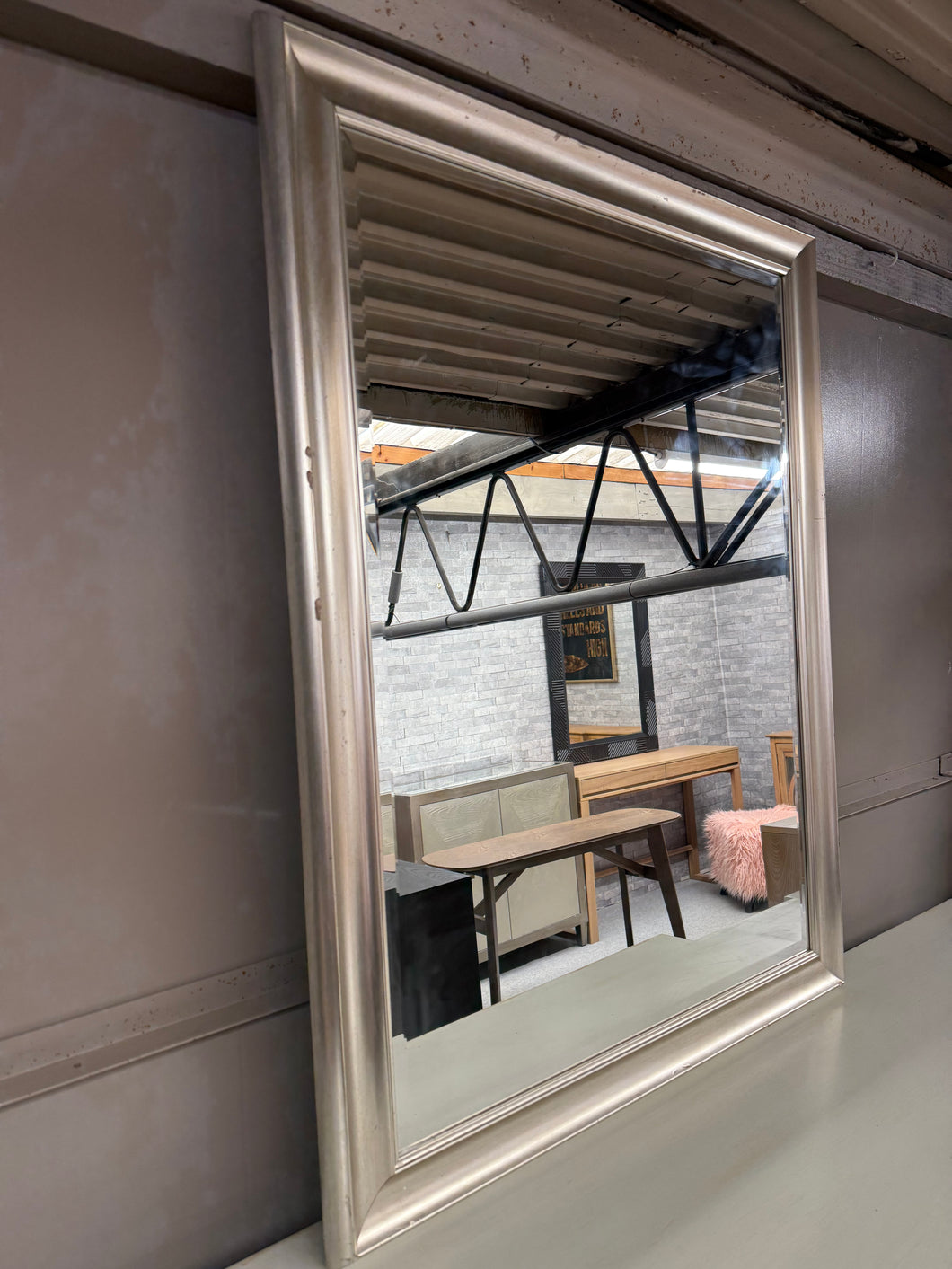 Brighten your space with this charming silver-framed mirror, complete with a lovely bevelled edge that adds classic elegance. Sturdy, this gently used mirror shows just the right amount of patina—proof of its enduring quality. 

Delivery Available

Overall Dimensions

91cm x 116.5cm        
