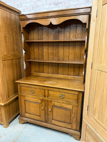 This beautiful solid oak dresser is sturdy and well-maintained. While it shows some signs of use, the marks are minor. It offers plenty of storage space, featuring two shelves above two dovetail-jointed drawers and a double cupboard at the base.

Overall Dimensions

107cm wide x 42.5cm deep x 182.5cm high

DELIVERY AVAILABLE      

HAVE THIS PAINTED A COLOUR OF YOUR CHOICE FOR AN EXTRA £100 OR HAVE IT COMPLETELY STRIPPED BACK FOR JUST £120    

For our other items see our website https://fossewayfurniture.c