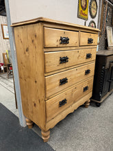 Load image into Gallery viewer, A striking antique pine chest of drawers with authentic character and reliable construction. Structurally sound and in good overall condition, it bears gentle age-related patina that enhances its vintage appeal. Features two short dovetail-jointed drawers positioned above three spacious long drawers, offering substantial storage capacity. The perfect statement piece to anchor a bedroom or living space with timeless charm and quality craftsmanship.

Delivery Available

Overall Dimensions

103cm wide x 44cm d
