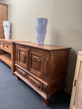 Load image into Gallery viewer, A versatile hardwood cupboard combining practical storage with vintage character. Features one spacious cupboard compartment above two useful drawers, offering flexible organisation for any room. Structurally sound and in good overall condition. The cupboard includes a distinctive hole detail that adds to its authentic charm without compromising functionality. Ideal for refinishing—responds beautifully to polishing or painting to suit your décor.

Delivery Available

Overall Dimensions

91cm wide x 49cm dee
