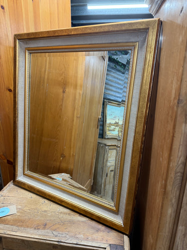 This beautiful ornate gold mirror features a bevelled edge that adds an elegant touch to any room. Structurally sound and overall in good condition, it carries a charming vintage character. While it is used and shows some marks, they are minor and do not detract from its stunning appearance. Perfect for brightening up your space, this mirror combines classic style with a touch of warmth and sophistication. 

Delivery Available

Overall Dimensions

65cm x 75cm 
