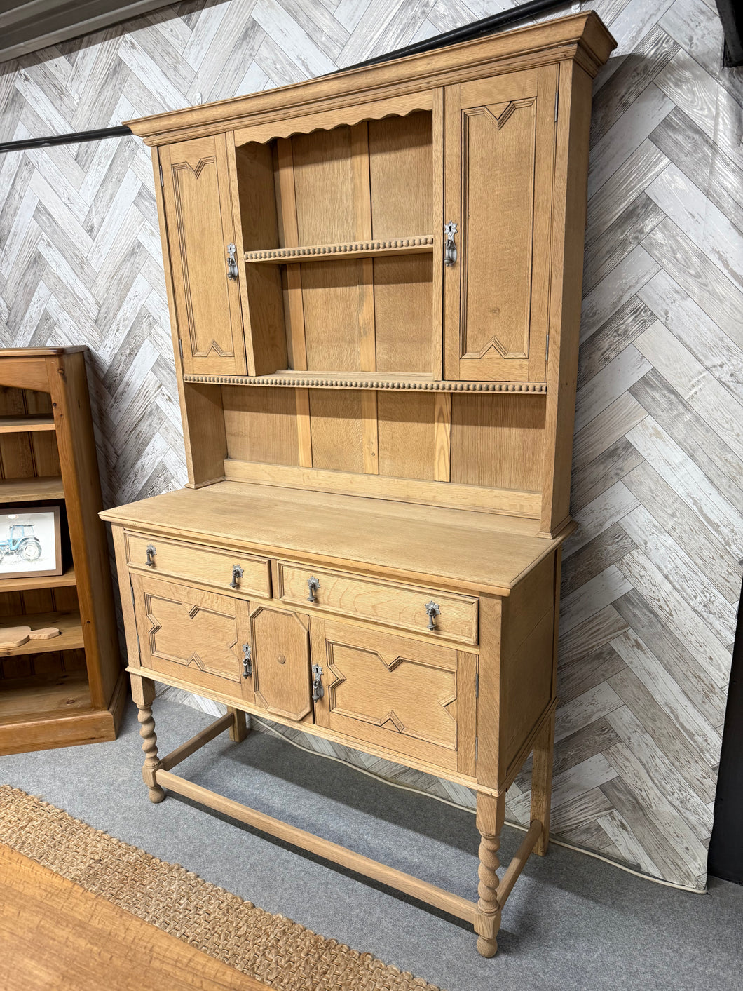 This beautiful solid oak dresser has been fully stripped to reveal its natural finish and would benefit from a wax coating to protect it. It’s pre-loved with some minor marks, but nothing too noticeable. The top section features two shelves and two cupboards above two drawers and a double cupboard. For easier transport, the top separates from the base.

Overall Dimensions

119cm wide x 48cm deep x 196cm high

DELIVERY AVAILABLE      

For our other items see our website https://fossewayfurniture.co.uk

coll