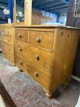 Load image into Gallery viewer, This solid vintage pine chest of drawers combines authentic character with practical storage. Structurally sound and in good overall condition, it features traditional dovetail jointed construction with two short drawers above two generous long drawers. As a genuinely used piece, it bears the natural patina and minor marks that add to its vintage charm. Ideal for bedrooms, living spaces, or anyone seeking quality period furniture with real heritage.

Delivery Available

Overall Dimensions

91.5cm wide x 50c
