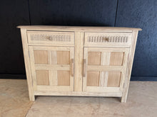 Load image into Gallery viewer, A beautiful stripped oak sideboard with authentic character and timeless appeal. Features two spacious short drawers positioned above a generous double cupboard, offering ample storage for dining rooms, hallways, or living spaces. The natural wood has been carefully stripped back to reveal the original grain and patina, creating a warm, organic finish that works with both traditional and contemporary interiors. The piece is structurally sound and in excellent condition. As with all stripped wood, a protecti
