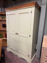 Load image into Gallery viewer, This solid pine wardrobe features a charming distressed green finish that adds character to any bedroom. Structurally sound and in excellent condition, it offers practical storage with one long hanging rail. The three-section design—two smaller compartments and one larger section—provides flexible organisation for your clothing and accessories.

Delivery Available

Overall Dimensions

136cm wide x 60cm deep x 190.5cm high&nbsp;

