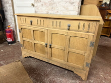 Load image into Gallery viewer, This beautiful oak sideboard has been fully restored to its natural finish and could use a wax coat to help protect it. It features two short drawers with dovetail joints above a double cupboard that includes one shelf. The piece is sturdy and remains in great overall shape.

Overall Dimensions

127cm wide x 48cm deep x 84cm high

DELIVERY AVAILABLE      

For our other items see our website https://fossewayfurniture.co.uk

collection from our shop at cv36, our collection zone at bs36 or otherwise delivery 
