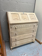 Load image into Gallery viewer, A beautifully restored oak bureau featuring a pull-down writing surface and four spacious dovetail-jointed drawers for practical storage. Stripped back to reveal the natural wood grain, it's structurally sound and ready for use—though a protective wax finish would enhance durability and appearance. An elegant, functional piece with genuine character and solid craftsmanship.

Delivery Available

Overall Dimensions

76cm wide x 41cm deep x 96cm high
