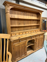 Load image into Gallery viewer, This elegant dresser is made of vintage pine and is in good condition with sturdy construction. Although it shows some marks of previous use, these only enhance its appeal. The top section features 2 fixed shelves and 5 short drawers, while the bottom section has 3 dovetail jointed drawers and 2 cupboards, providing ample storage space. The piece can be separated into 2 parts for easier transportation.

Overall Dimensions

179.5cm wide x 50cm deep x 197cm high

DELIVERY AVAILABLE      

For our other items 
