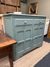 Load image into Gallery viewer, A striking oak sideboard finished in Frenchic's 'Steaming Green'—a sophisticated statement piece for any room. Built with solid joinery, this sideboard combines timeless design with practical storage. Two dovetail-jointed drawers sit above a generous double cupboard, offering ample space for dining essentials etc.&nbsp;

Delivery Available

Overall Dimensions

94cm wide x 40cm deep x 84cm high

