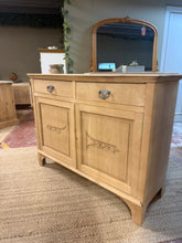 Load image into Gallery viewer, A beautiful stripped oak sideboard revealing the wood's natural character and grain. Structurally sound with excellent bones, this piece features two dovetail-jointed drawers above a double cupboard with internal shelf and divider—ideal for organised storage. A light coat of wax will enhance protection and bring out the oak's warmth. Minor wear to one back corner is present but doesn't affect its use. Includes key. Ready to become a statement piece in any room.

Delivery Available

Overall Dimensions

121.5
